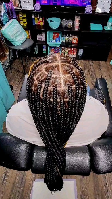 Hip-length knotless braids in the chair